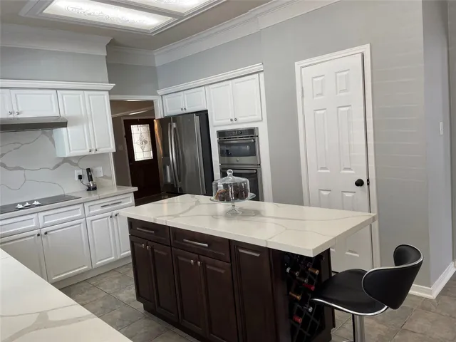 a kitchen with a table chairs sink and cabinets