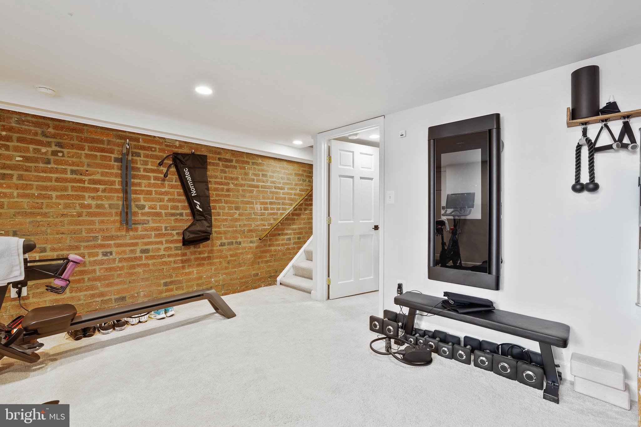 1215 33rd Street Northwest Washington, DC 20007 - Photo 27 of 37 a room with gym equipment and mirror