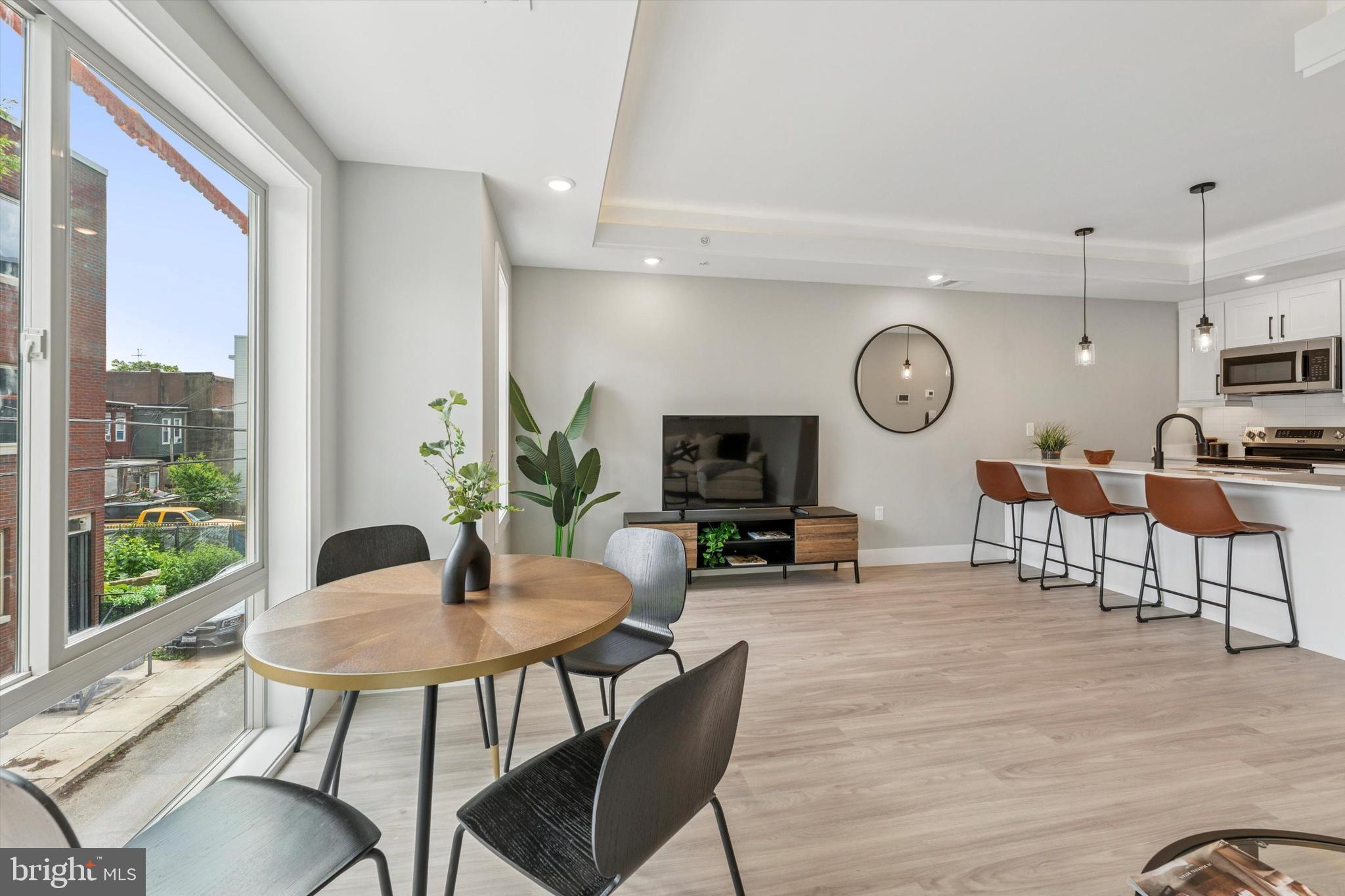 2401 North 2nd Street, Unit F3 Philadelphia, PA 19133 - Photo 19 of 26 a view of a dining room with furniture window and wooden floor