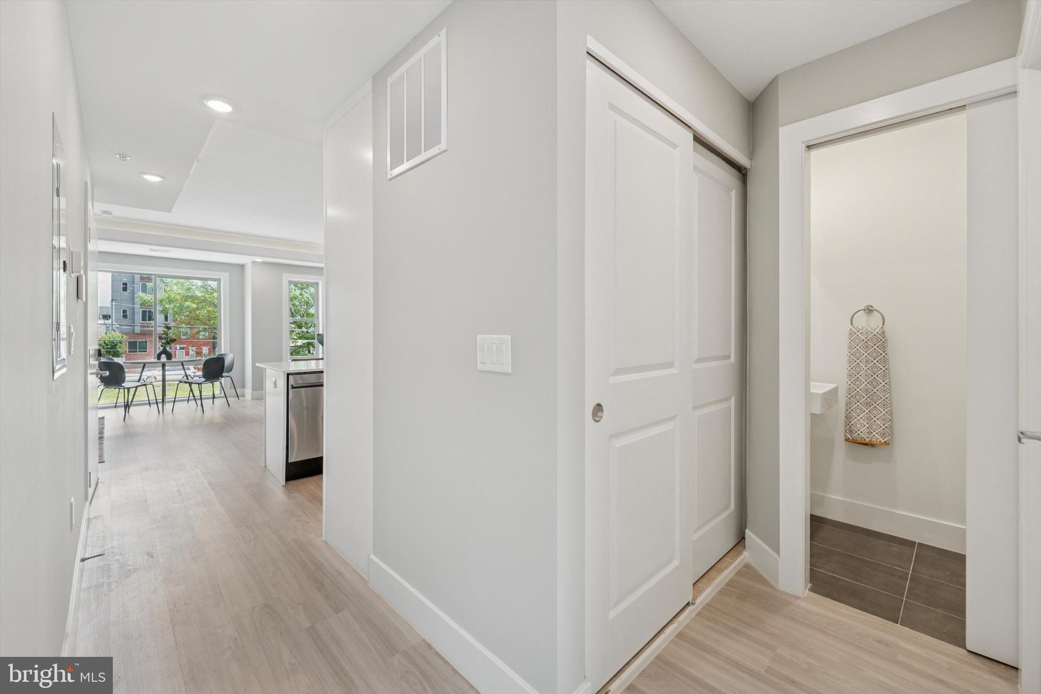 2401 North 2nd Street, Unit F3 Philadelphia, PA 19133 - Photo 3 of 26 a view of a hallway with wooden floor and a living room