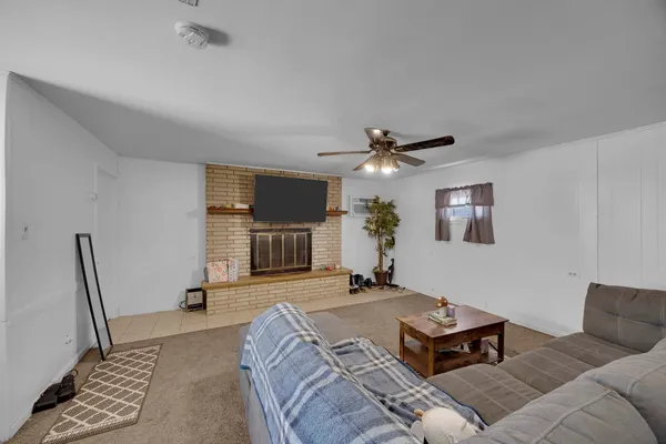 a bedroom with a bed couch and a fireplace