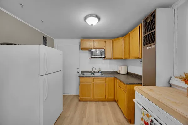 a kitchen with a refrigerator a stove top oven a sink and dishwasher