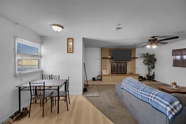 a living room with furniture and a dining table