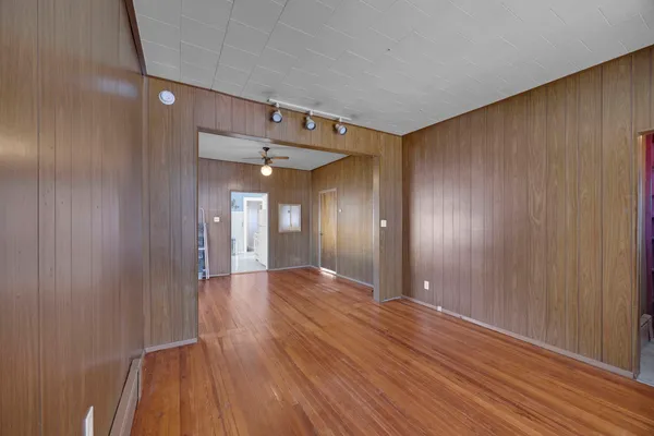 a view of a hallway with wooden floor
