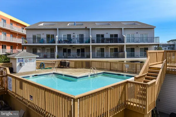 a view of a house with pool and deck