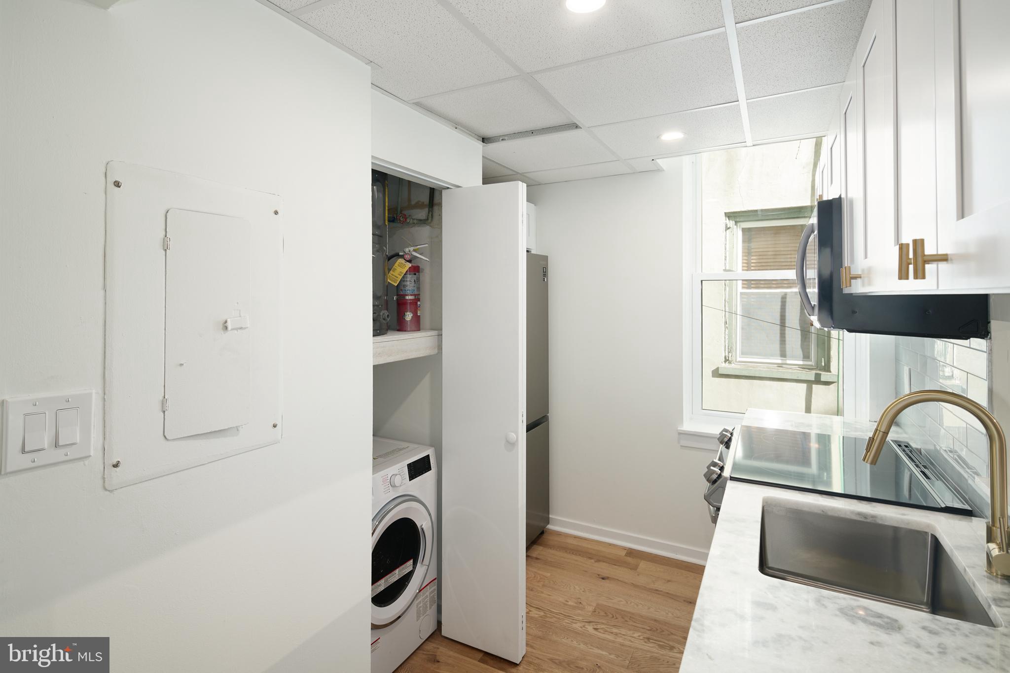 1716 Wallace Street, Unit 202 Philadelphia, PA 19130 - Photo 3 of 12 a kitchen with stainless steel appliances granite countertop a sink a stove and refrigerator