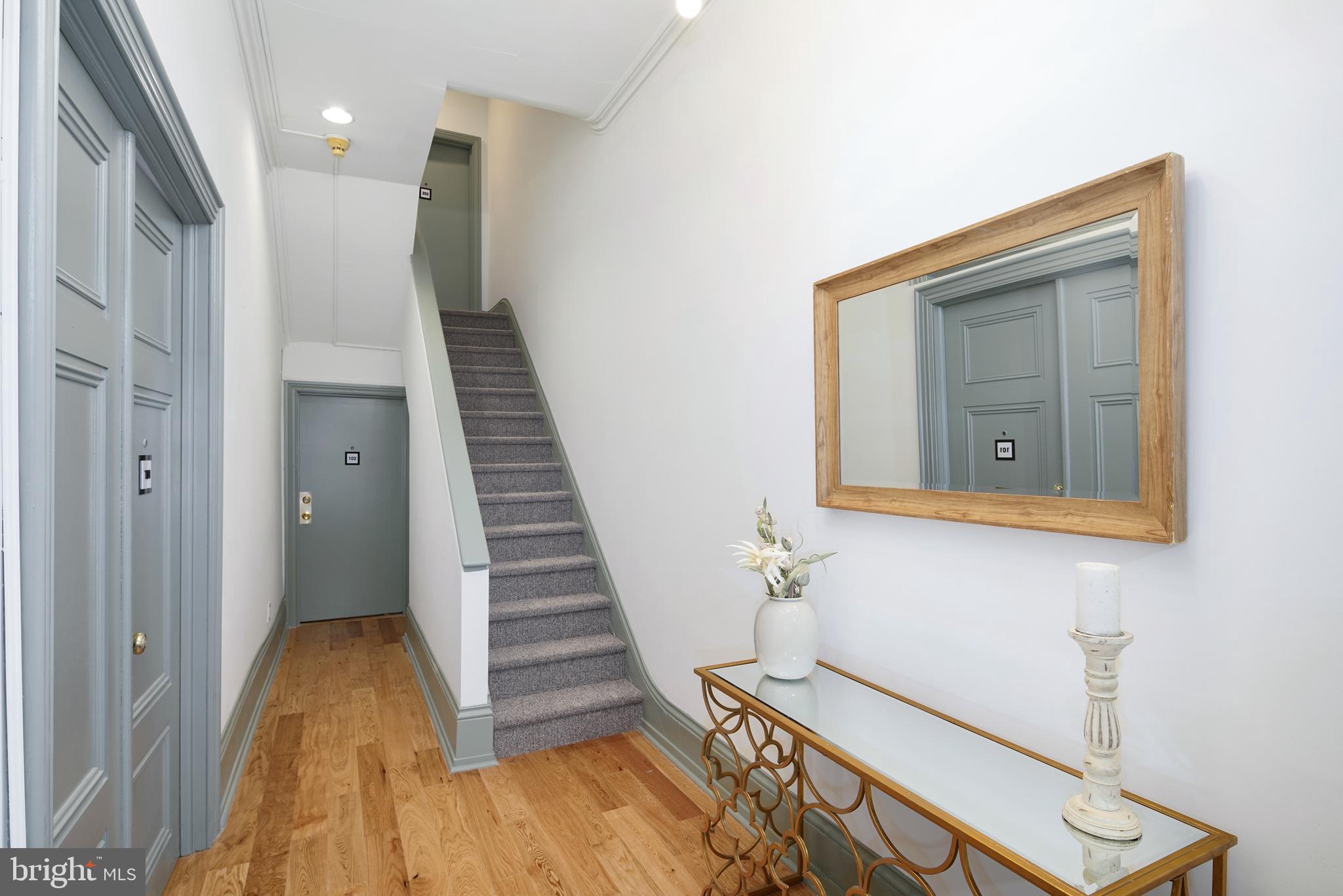 1716 Wallace Street, Unit 202 Philadelphia, PA 19130 - Photo 9 of 12 a view of a hallway with wooden floor and staircase
