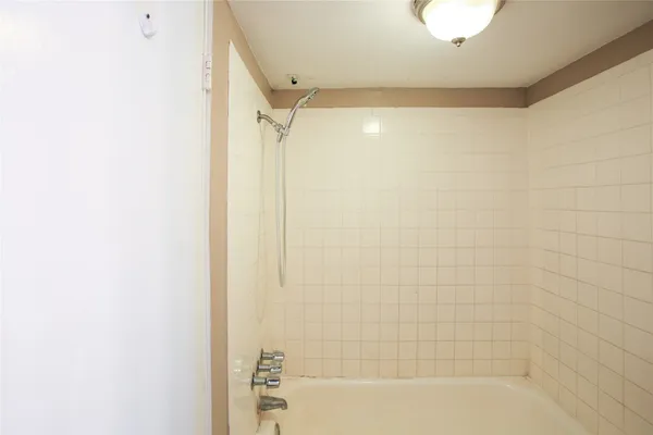 a bathroom with a shower and a bathtub
