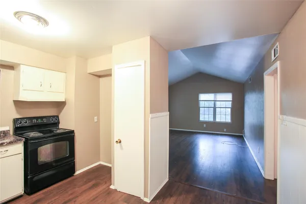 a view of kitchen and hallway with wooden floor