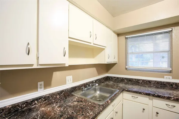 a kitchen with a sink and a window