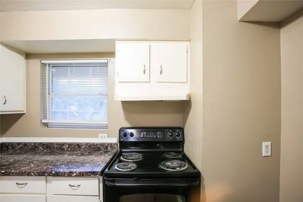 a stove top oven sitting inside of a kitchen