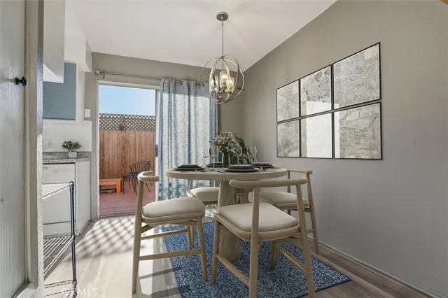 a dining room with furniture a chandelier and wooden floor