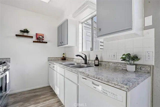a kitchen with sink and mirror
