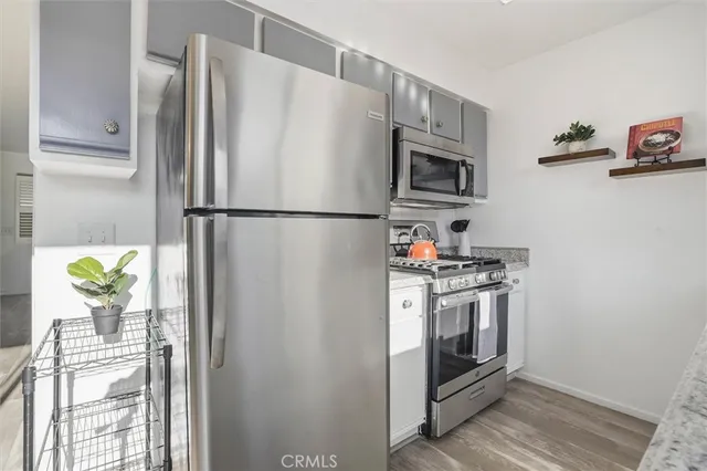 a white refrigerator freezer and a stove sitting inside of a kitchen