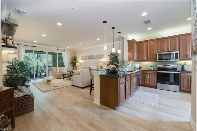 a kitchen with counter top space appliances and a ceiling fan