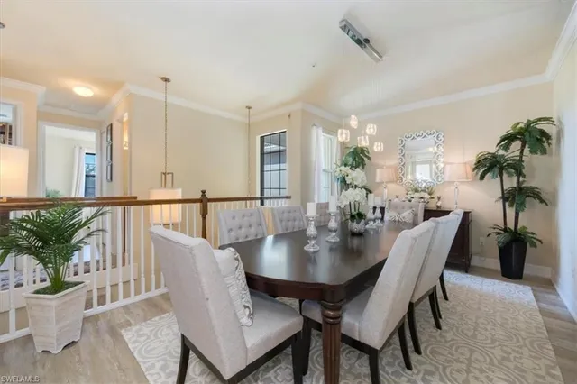 a view of a dining room and livingroom view with furniture and a potted plant