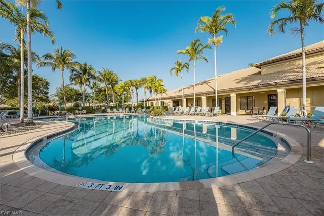 a view of a swimming pool with outdoor seating