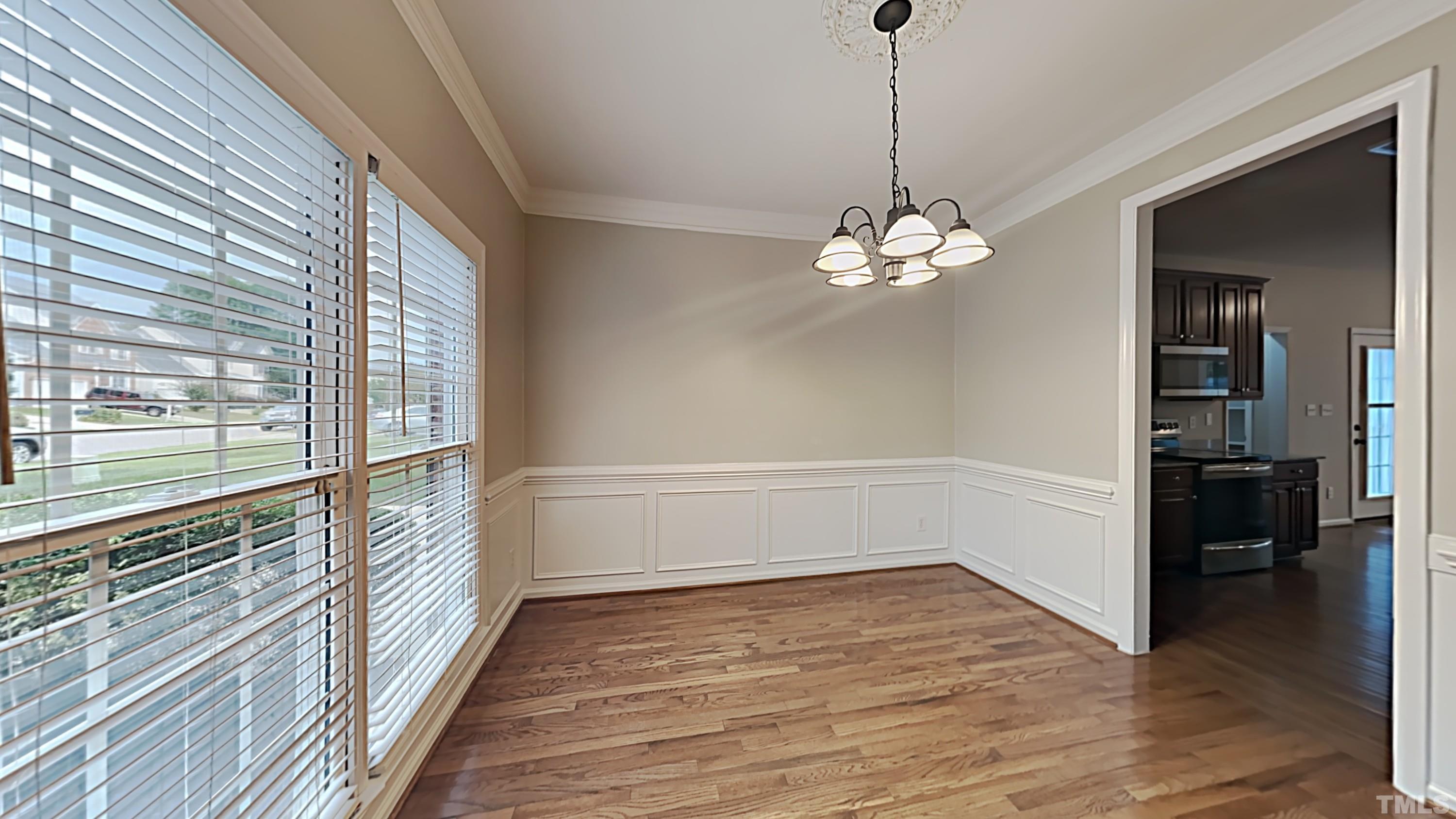 5020 Amberfield Way Raleigh, NC 27604 - Photo 2 of 24 a view of a room with wooden floor and chandelier