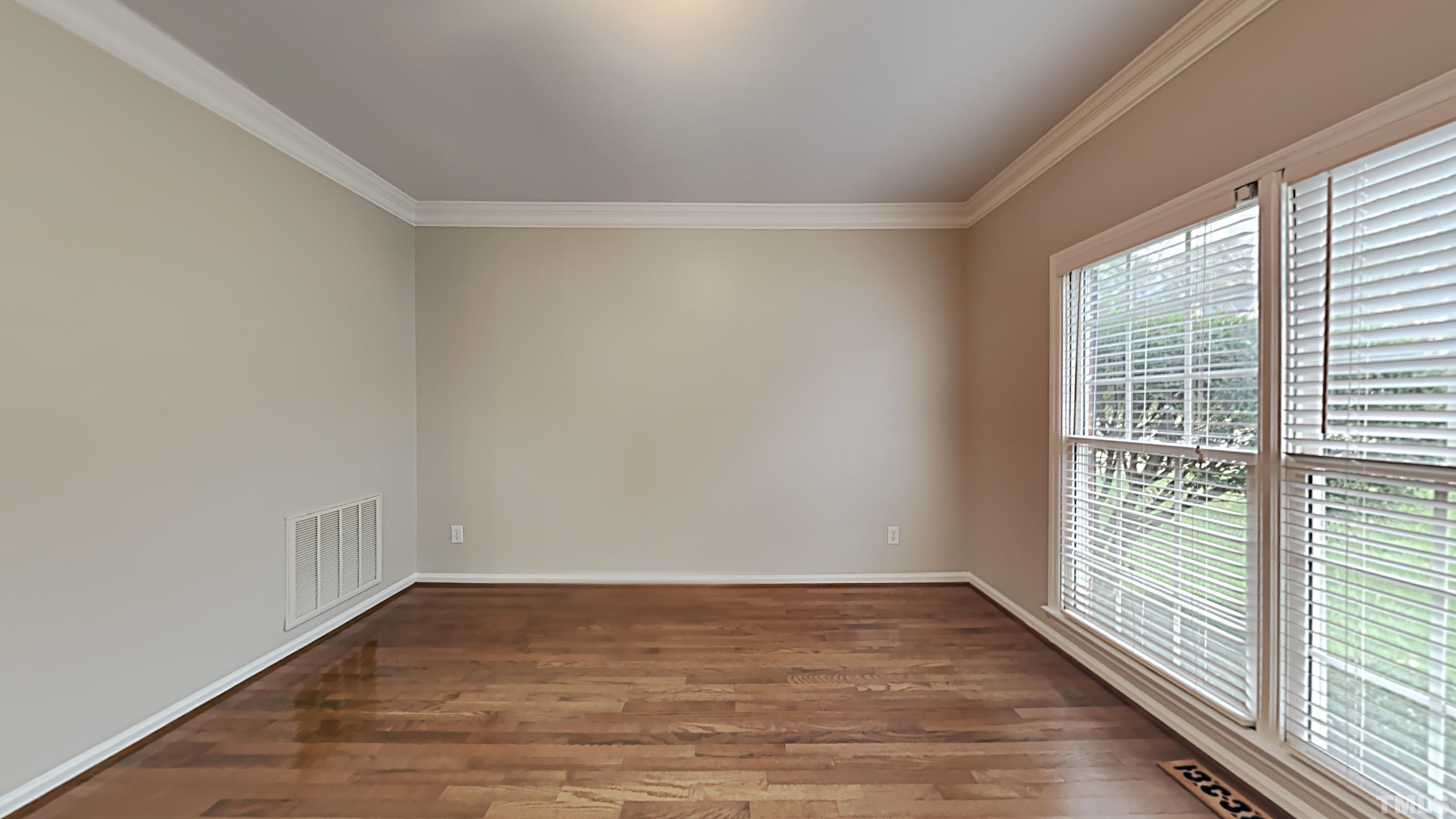 5020 Amberfield Way Raleigh, NC 27604 - Photo 3 of 24 a view of an empty room with wooden floor and a window