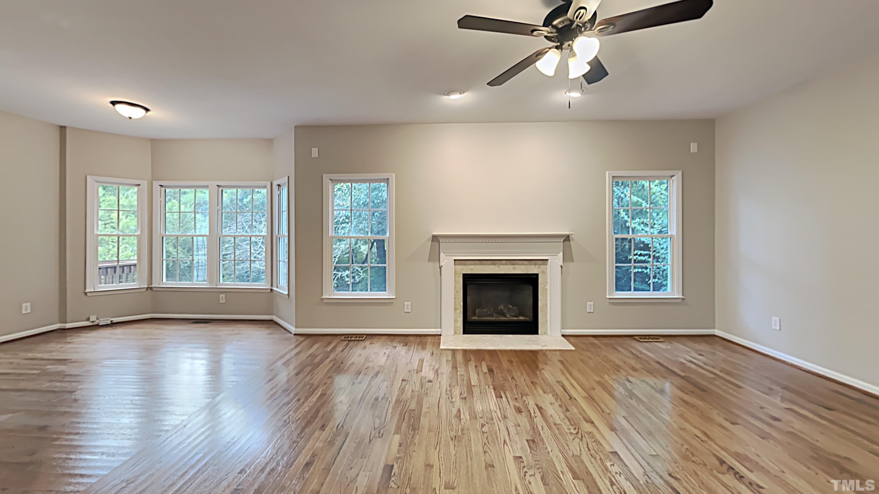 5020 Amberfield Way Raleigh, NC 27604 - Photo 4 of 24 a view of an empty room with wooden floor and a window