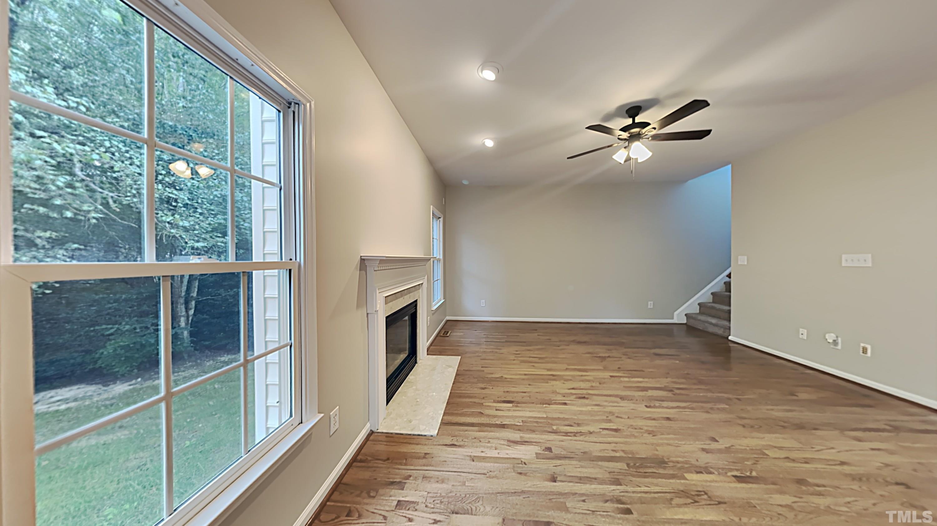 5020 Amberfield Way Raleigh, NC 27604 - Photo 5 of 24 a view of a livingroom with a ceiling fan and window