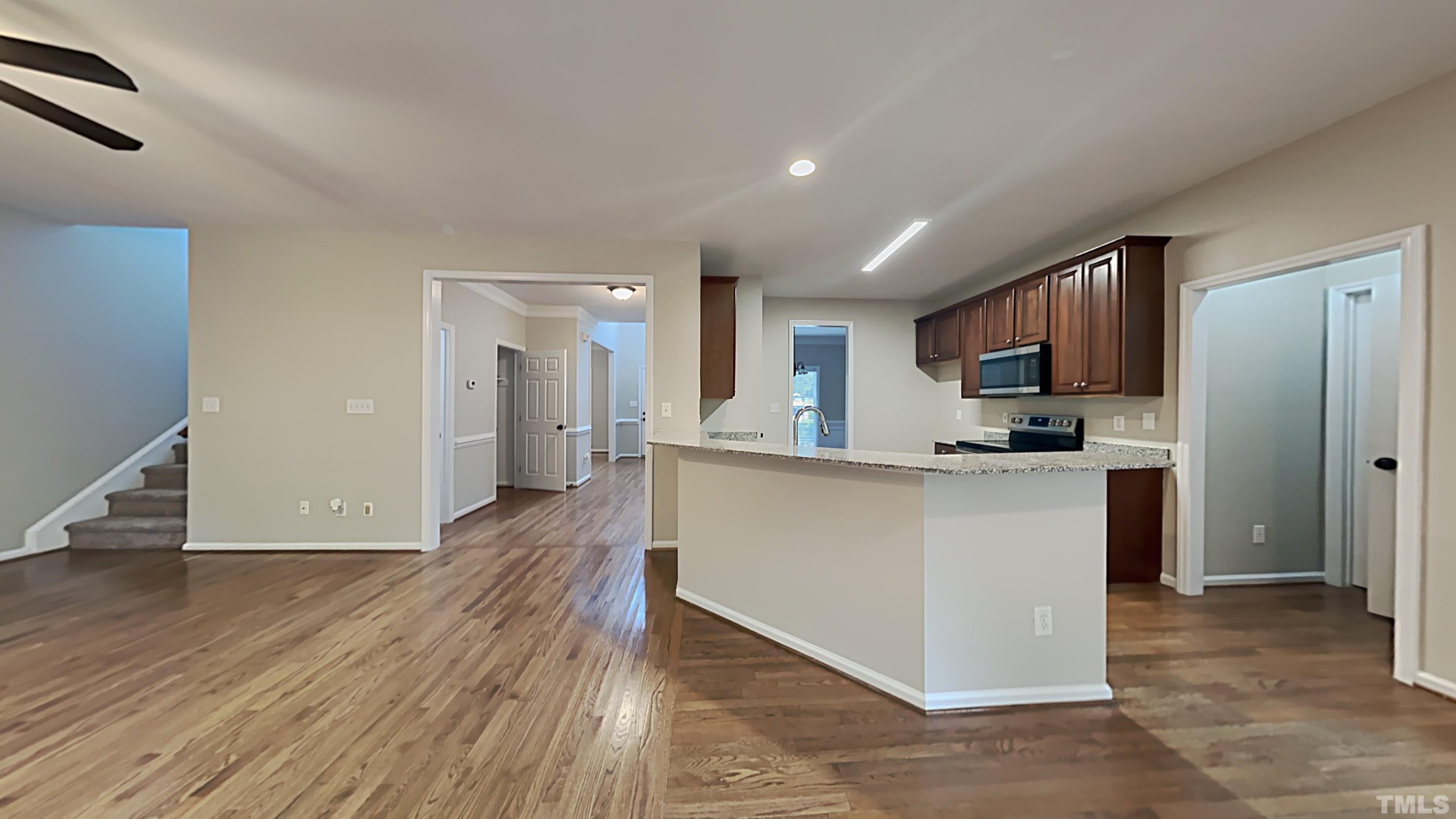 5020 Amberfield Way Raleigh, NC 27604 - Photo 6 of 24 a kitchen with stainless steel appliances granite countertop a refrigerator and a sink