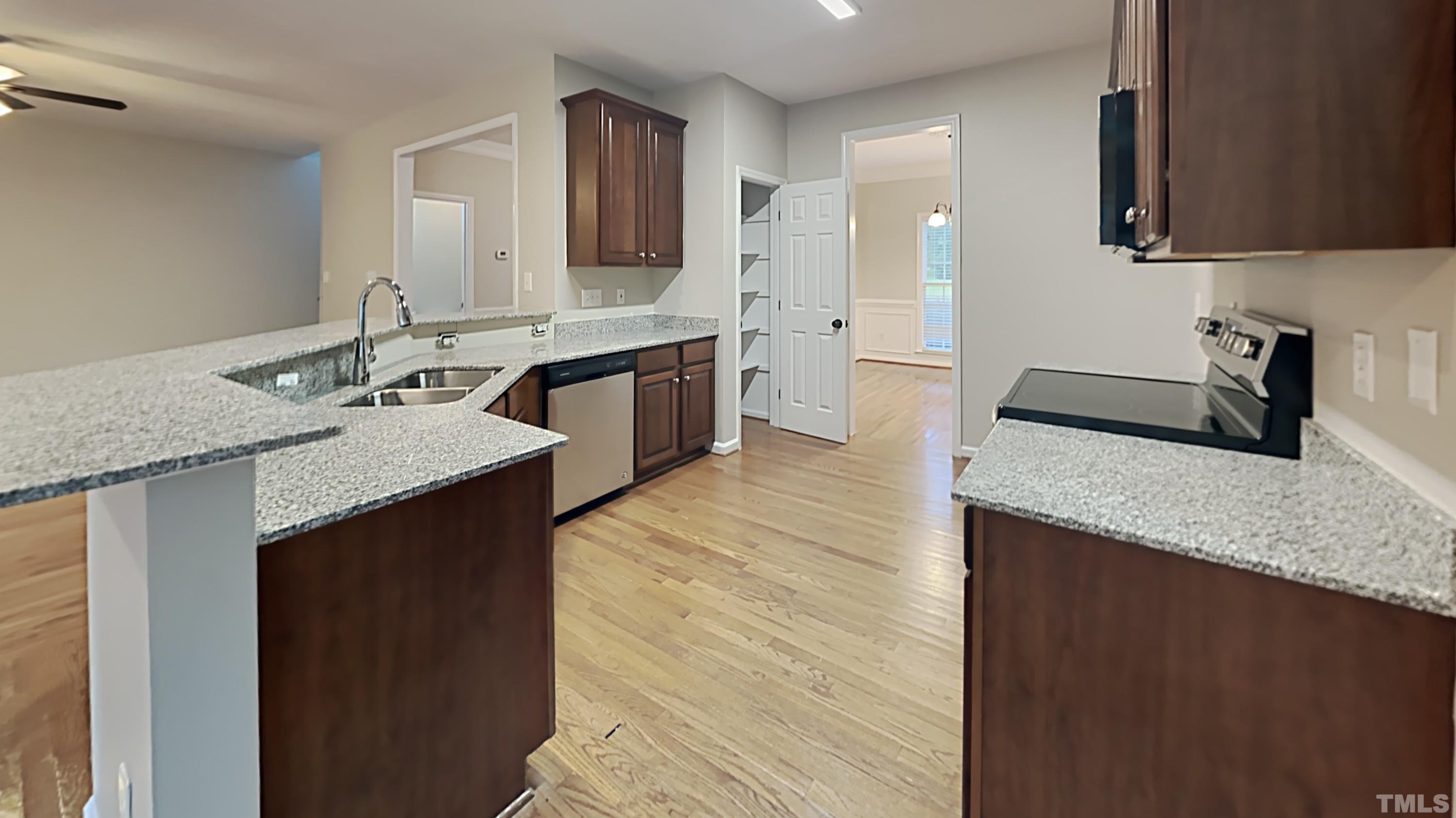 5020 Amberfield Way Raleigh, NC 27604 - Photo 7 of 24 a kitchen with stainless steel appliances granite countertop a sink stove and refrigerator