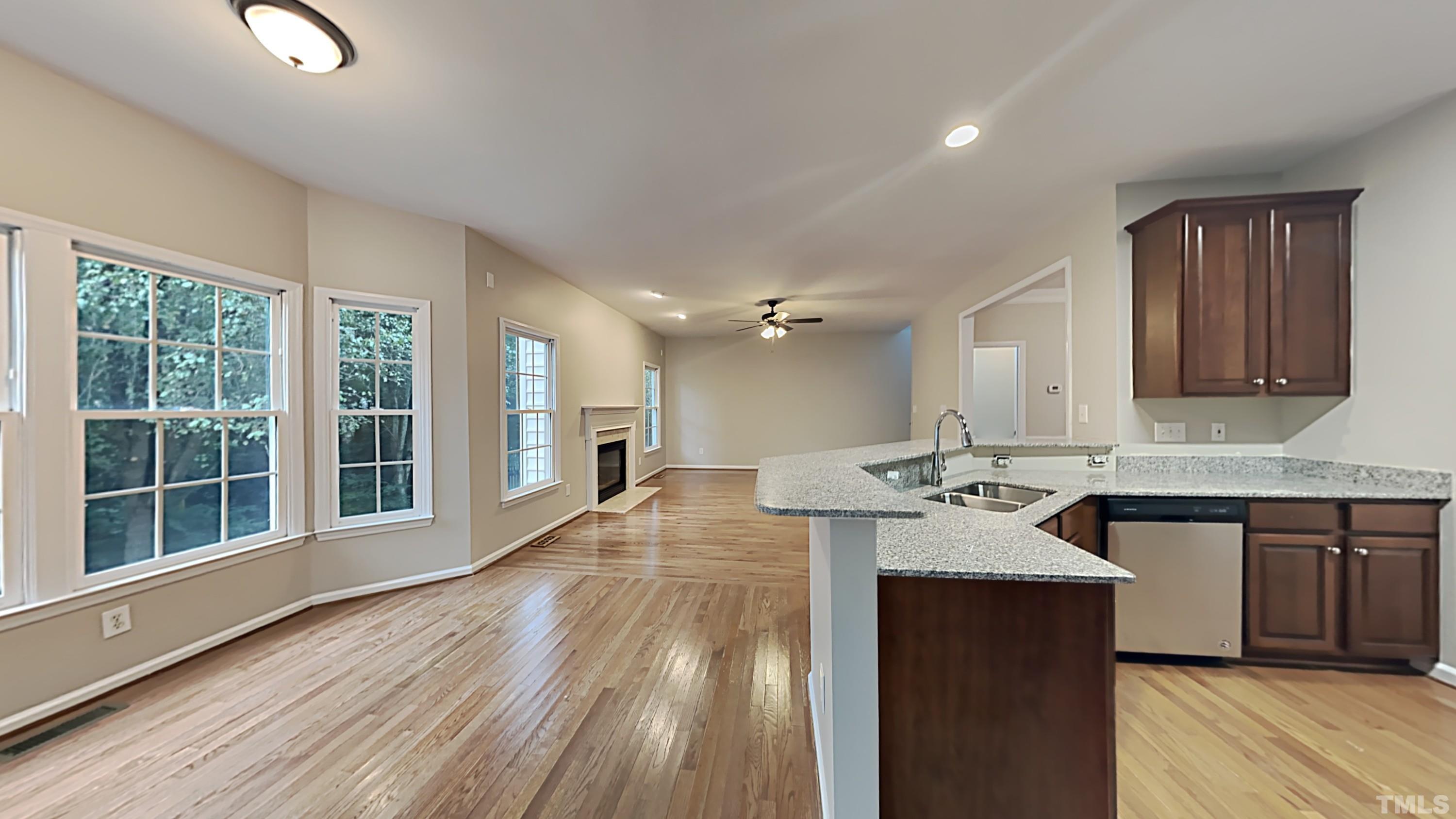 5020 Amberfield Way Raleigh, NC 27604 - Photo 8 of 24 a kitchen with a sink stove and wooden cabinets