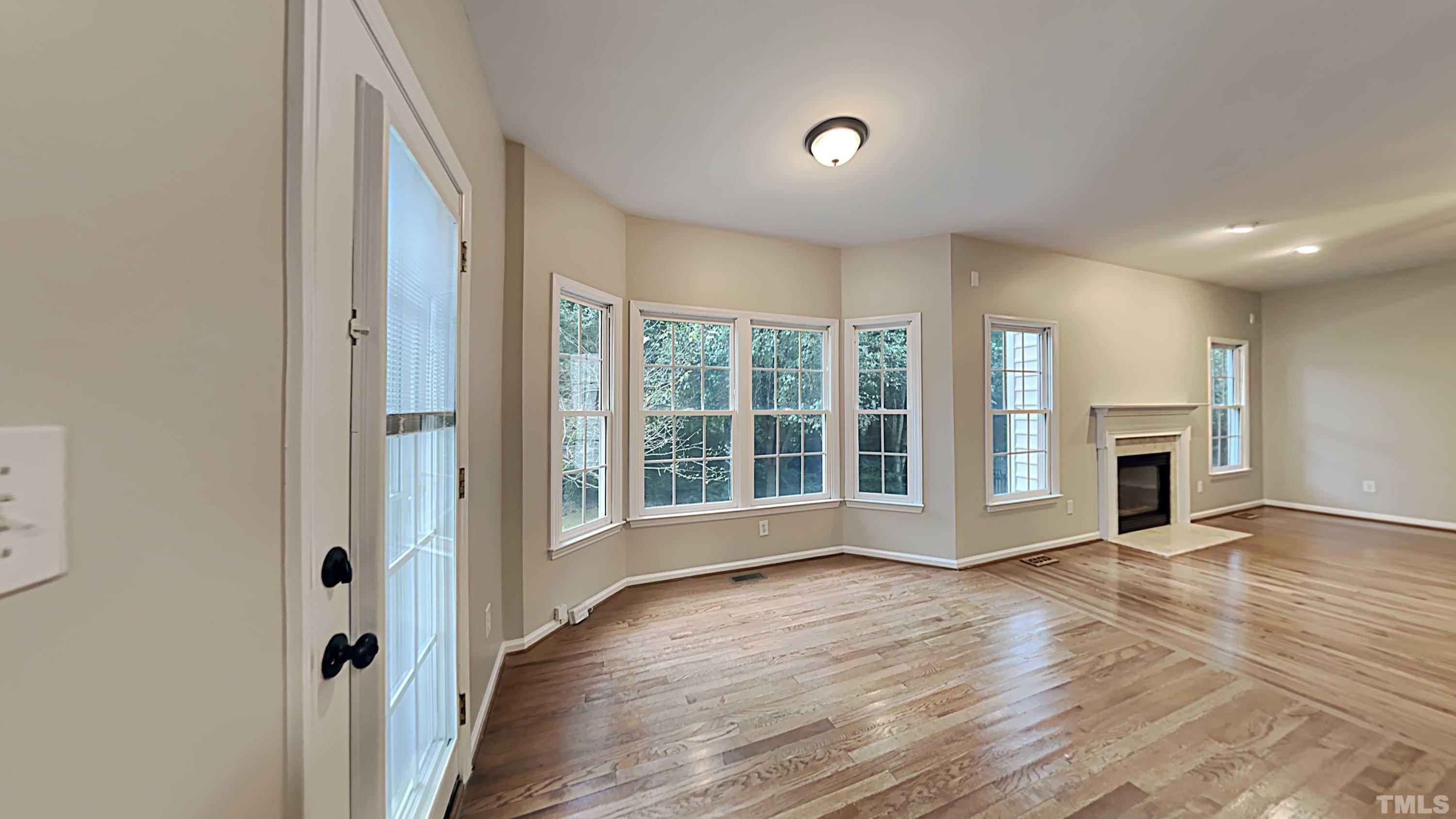 5020 Amberfield Way Raleigh, NC 27604 - Photo 9 of 24 a view of an empty room with wooden floor and a window