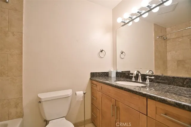 a view of a patio with table and chairs potted plants and palm trees