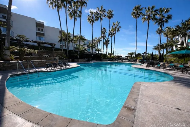 a view of a patio with couches table and chairs and potted plants