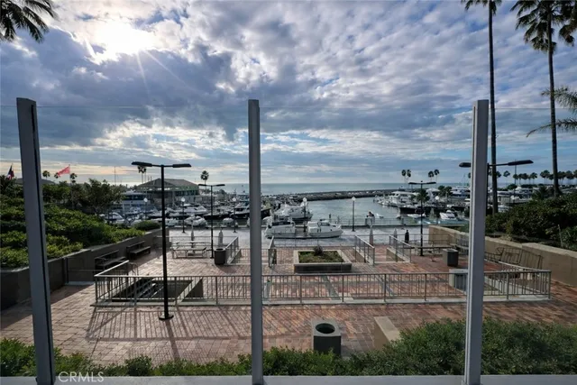 a view of living room kitchen with stainless steel appliances kitchen island sink and living room view
