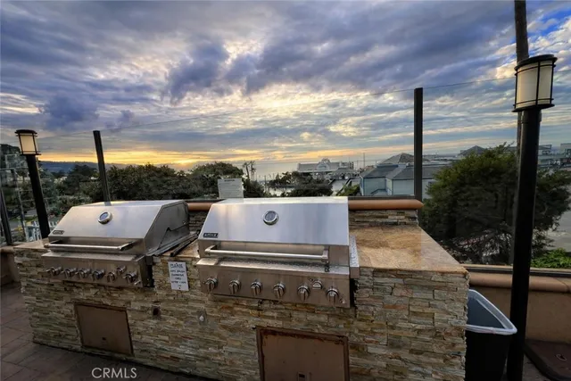a view of a street with potted plants and large trees