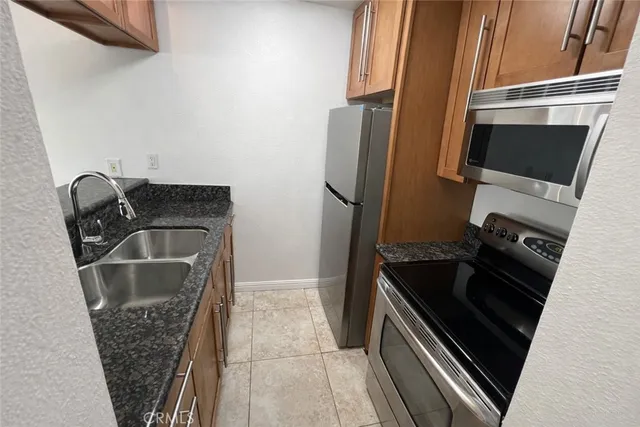 a bathroom with a granite countertop sink mirror vanity and toilet