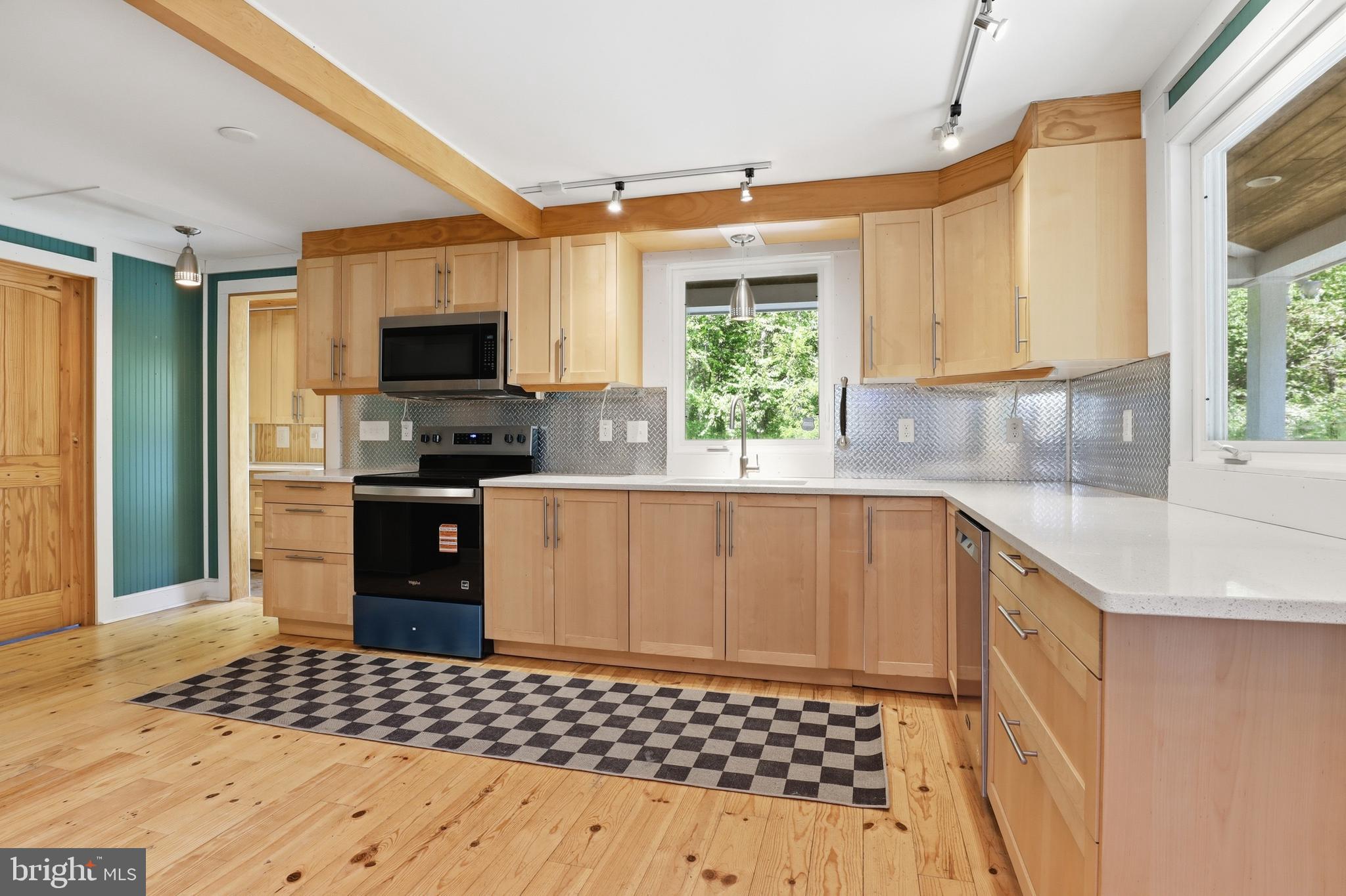 293 Grove Road Delta, PA 17314 - Photo 5 of 36 a kitchen with granite countertop a sink and a stove top oven