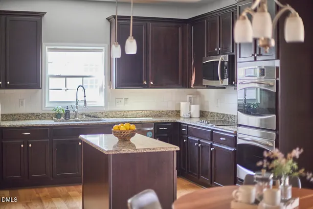 a dining room with furniture a chandelier and wooden floor