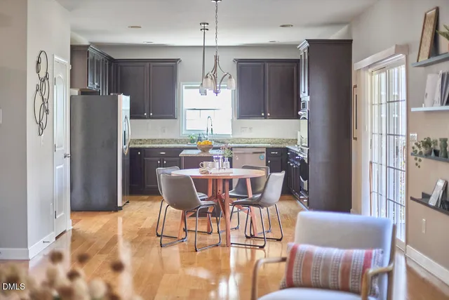 a living room with furniture a fireplace and a window