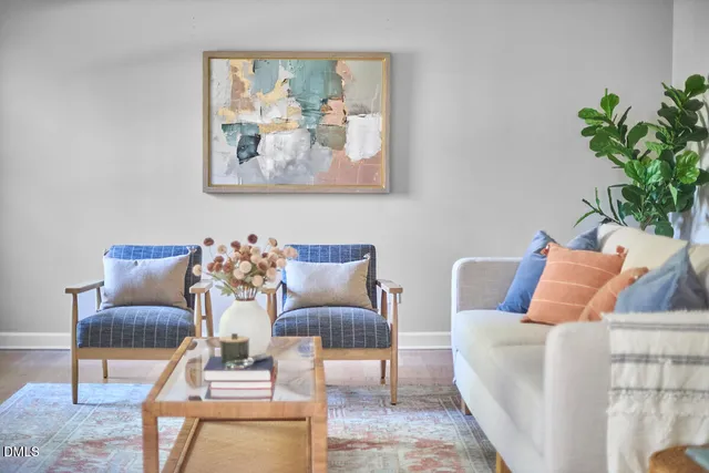 a living room with a bed furniture and a window