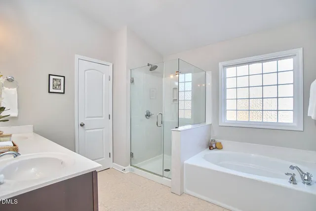 a bathroom with a double vanity sink and a mirror