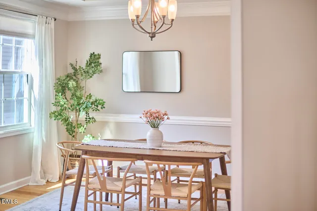 a dining room with furniture and wooden floor