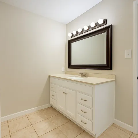 a bathroom with a sink vanity and a mirror