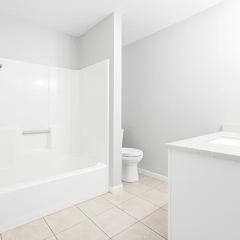 a white bath tub sitting next to a white toilet