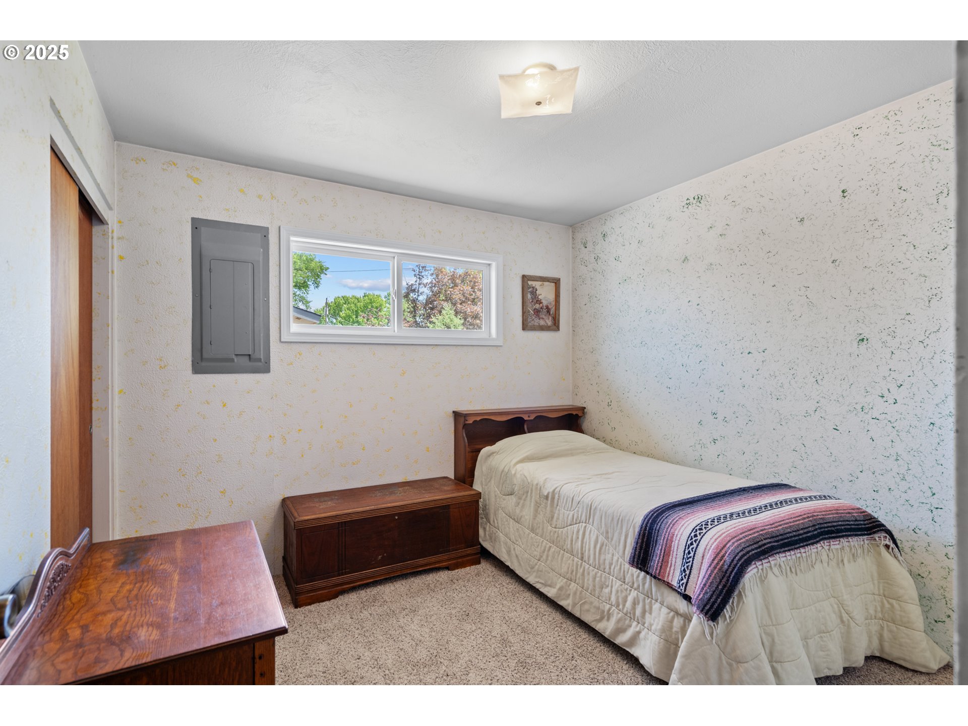 814 Southwest 44th Street Pendleton, OR 97801 - Photo 24 of 35 a bedroom with a bed and a painting on the wall