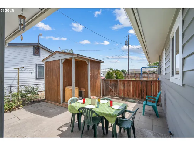 a view of a backyard with a table and chairs