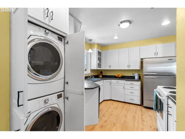 a kitchen with a refrigerator a sink and cabinets