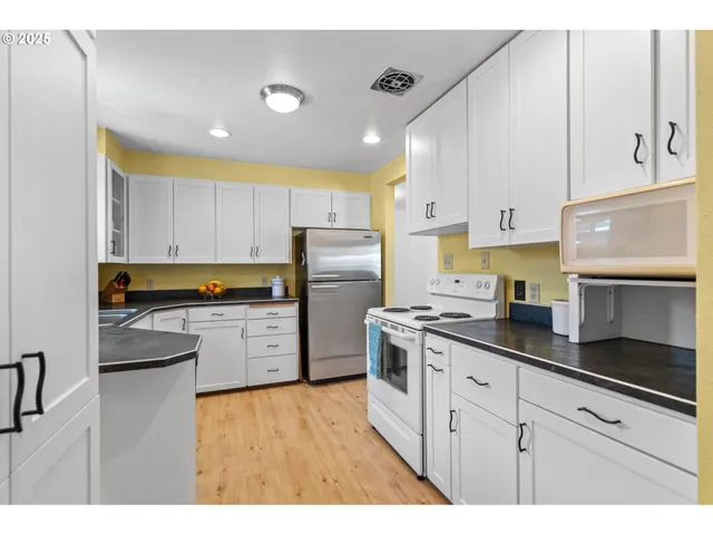 a kitchen with a sink a stove and refrigerator