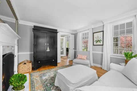 a living room with furniture a rug and a window