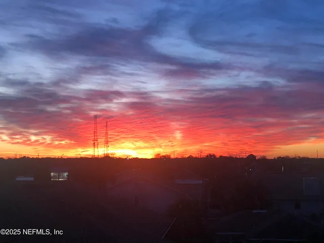 a living room with furniture wooden floor and a large window