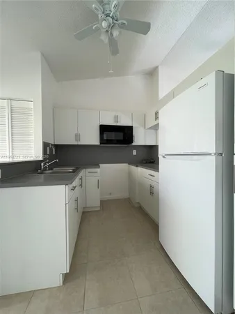 a kitchen with a refrigerator and a stove