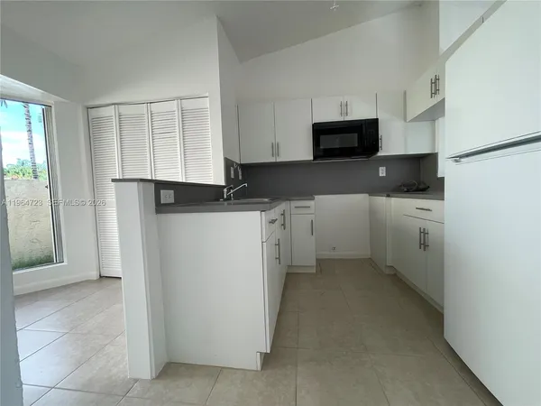 a kitchen with a refrigerator stove and cabinets